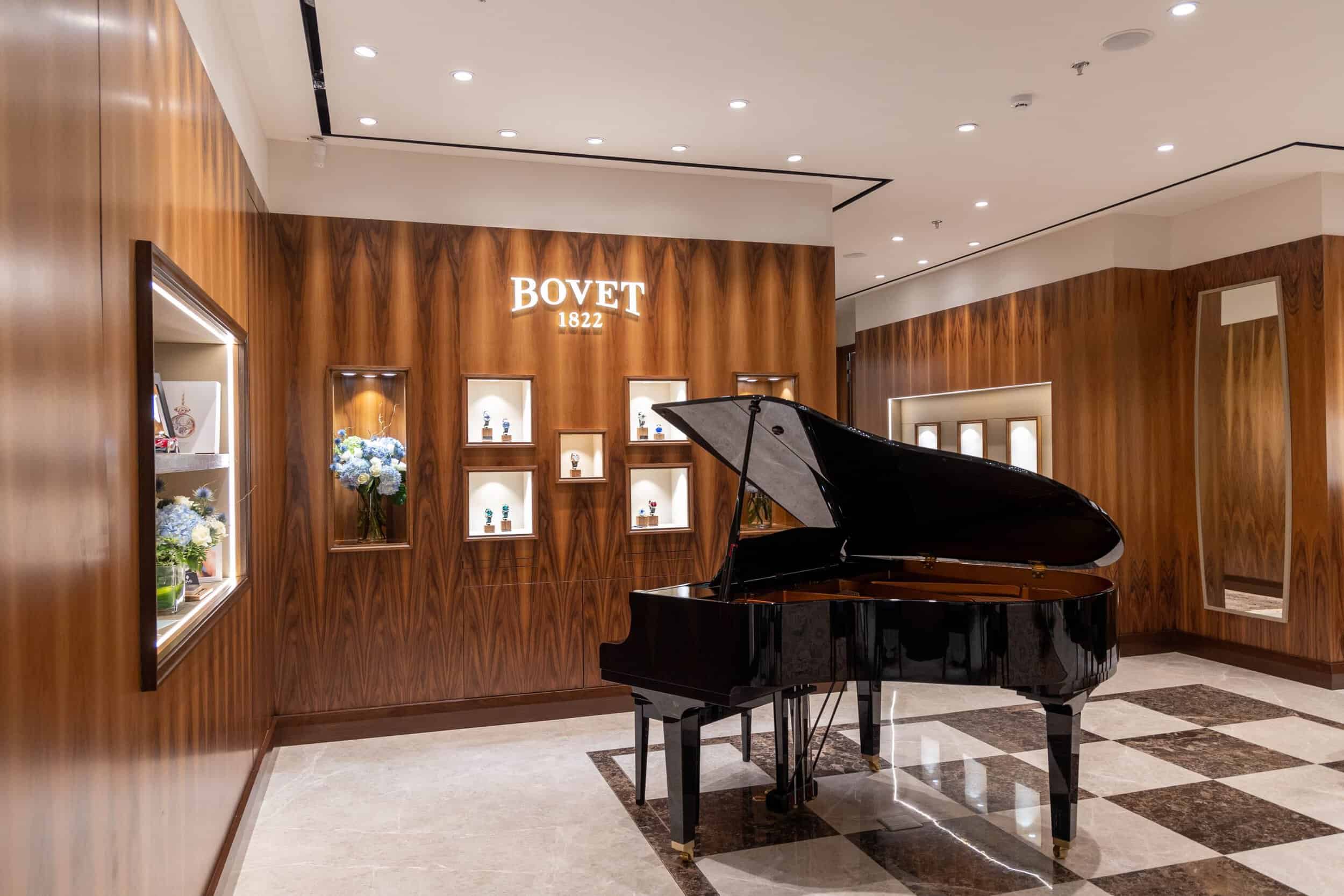 Elegant Bovet boutique interior with grand piano and wooden accents in Saudi Arabia.
