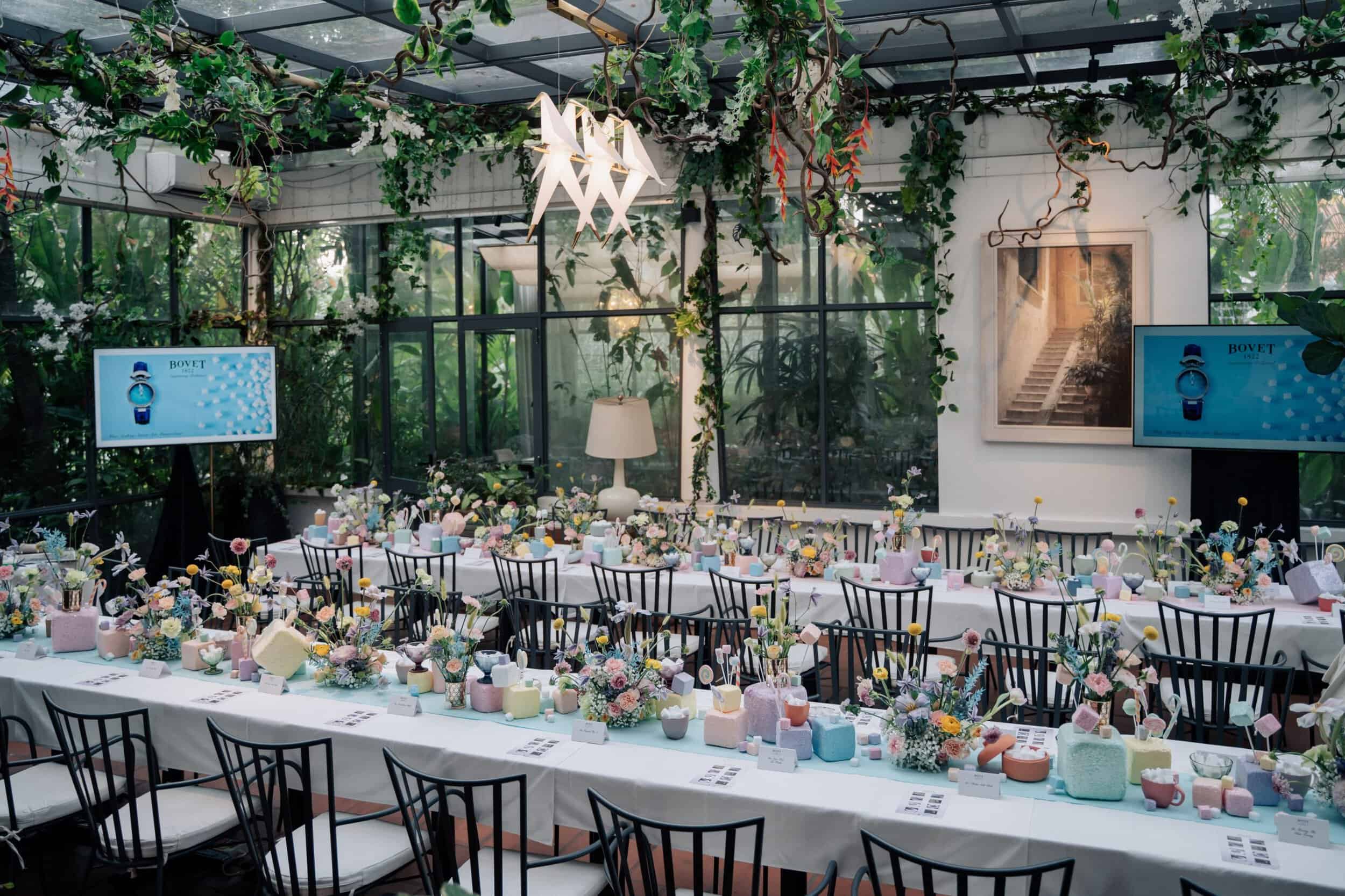 Elegant indoor event space with floral decor and table settings, perfect for celebrating special occ.