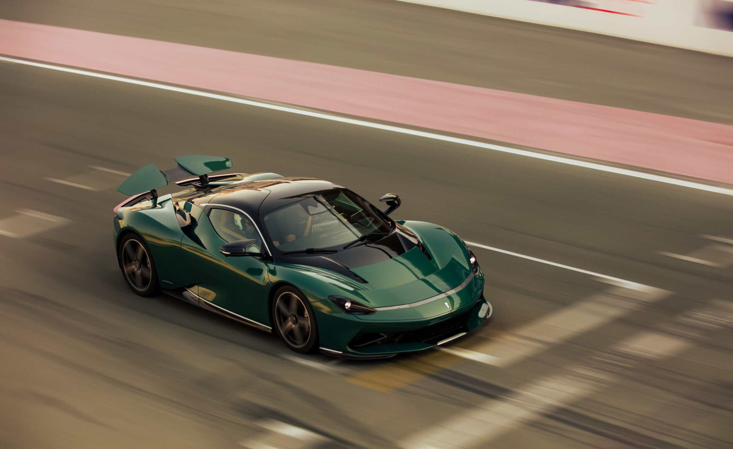 High-performance green sports car racing on track with sleek design and aerodynamic features.