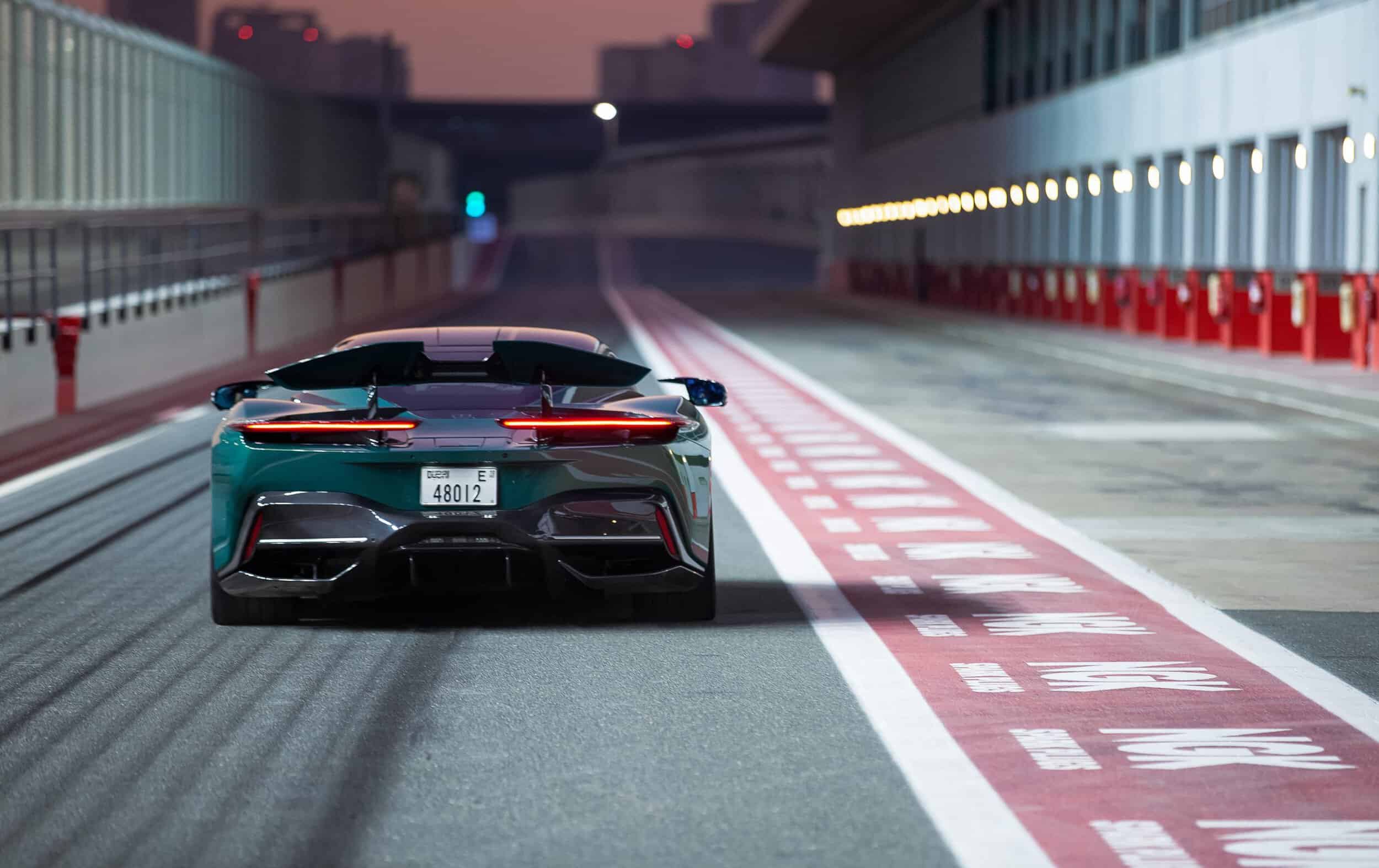 Luxurious green sports car on a race track with a focus on precision timepieces.