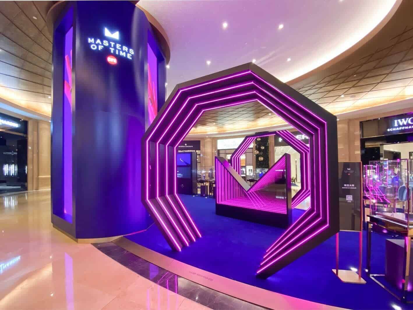 Elegant purple-lit display featuring Bovet timepieces at a luxury retail event.
