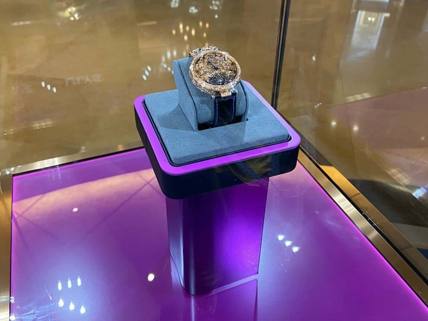 Luxurious BOVET 1822 timepiece displayed on a purple pedestal in a showroom.