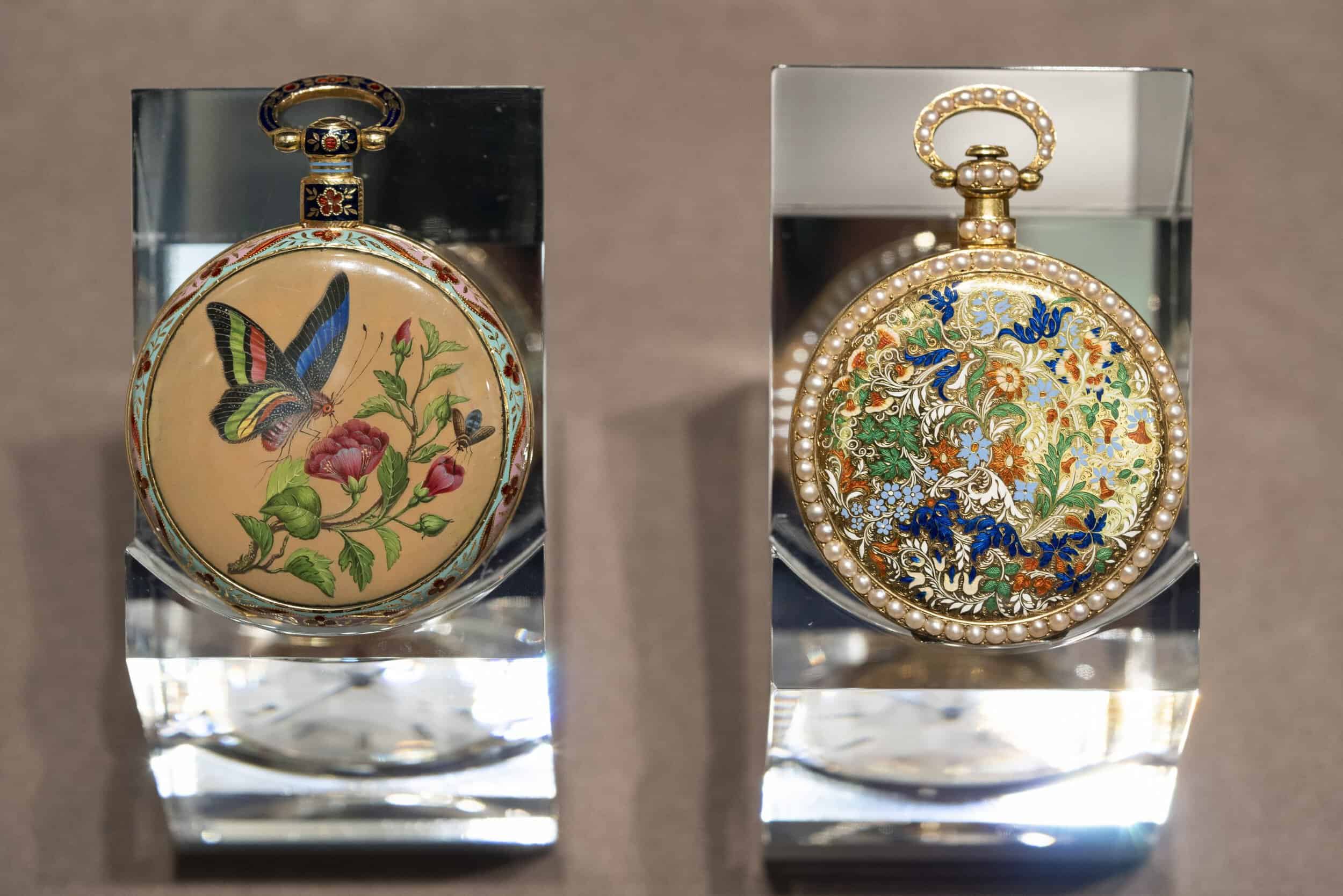 Exquisite antique timepieces with intricate floral and bird designs, showcasing 200 years of craftsm.