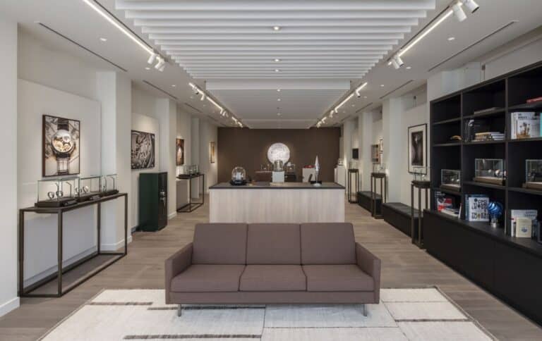 Elegant Bovet timepieces displayed in a modern showroom with sleek furniture and artwork.